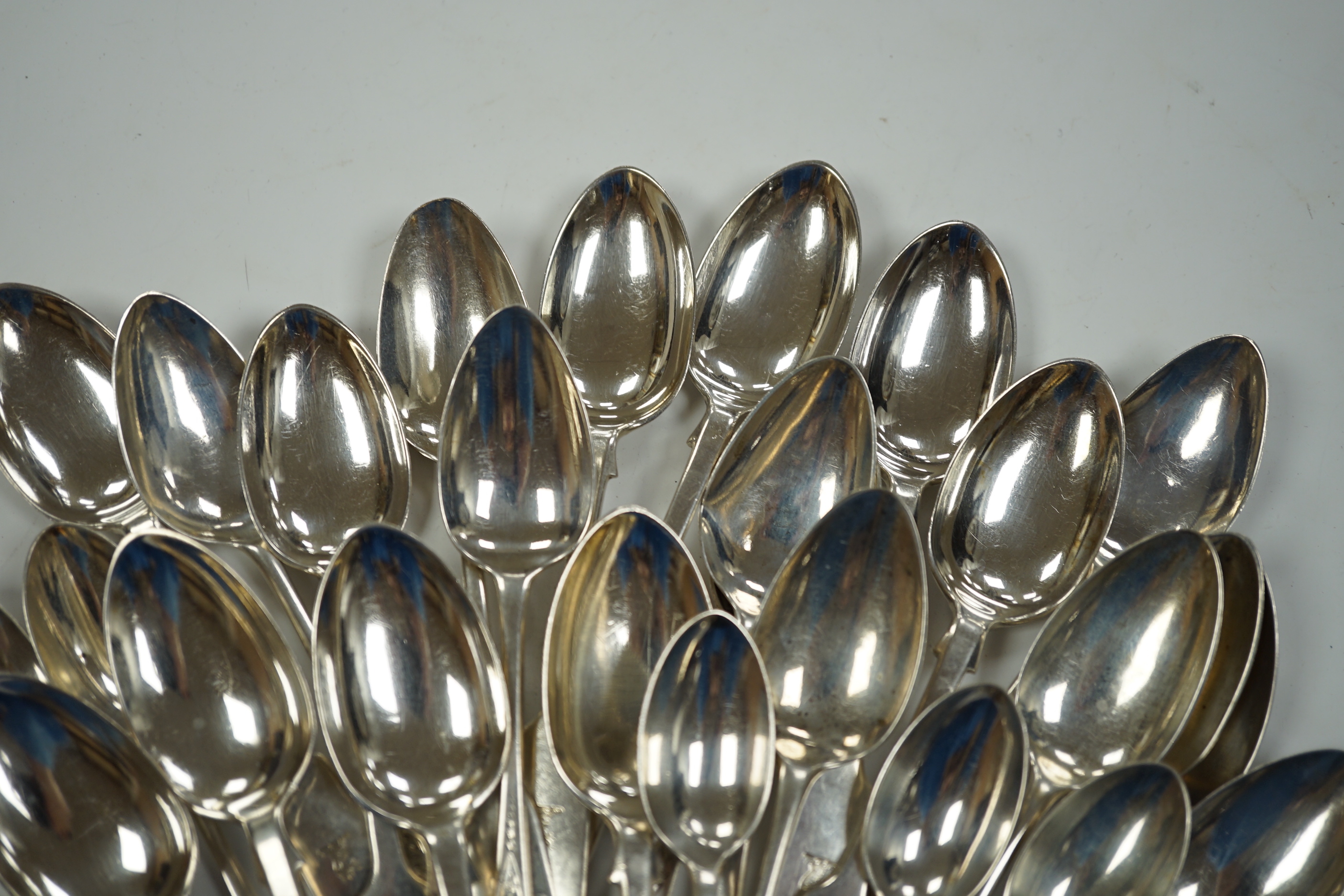 A set of eleven late Victorian silver fiddle pattern teaspoons, London, 1892 and sixteen earlier assorted silver teaspoons, 15.4oz.